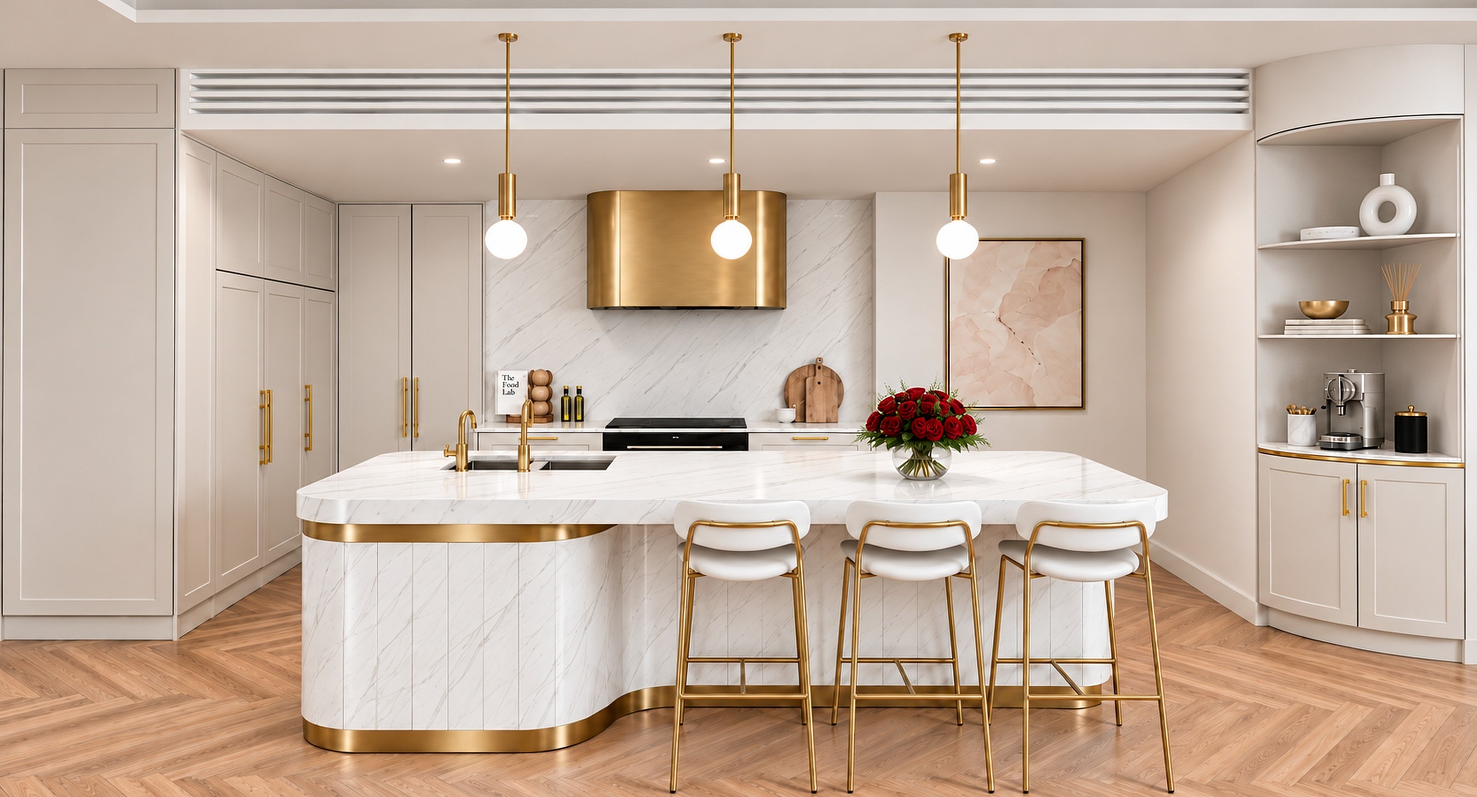 A sculptural stone island with brass stools, a brushed-bronze rangehood, soft two-pack joinery and red roses in a clear glass vase on the bench.