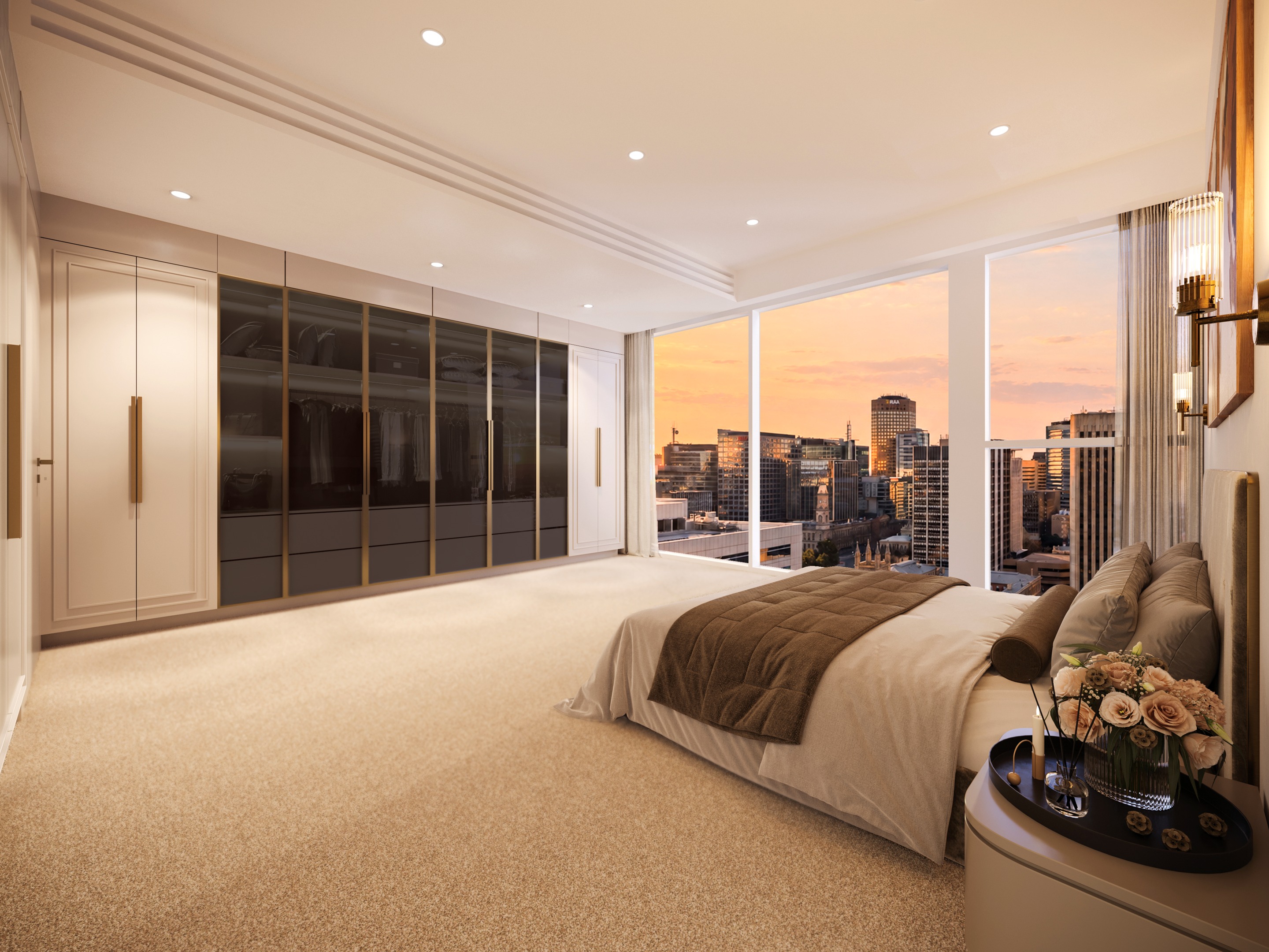 Master bedroom at dusk, with a wall of bronze-framed glass wardrobes, a bed facing full-height corner windows and the Adelaide skyline at sunset.