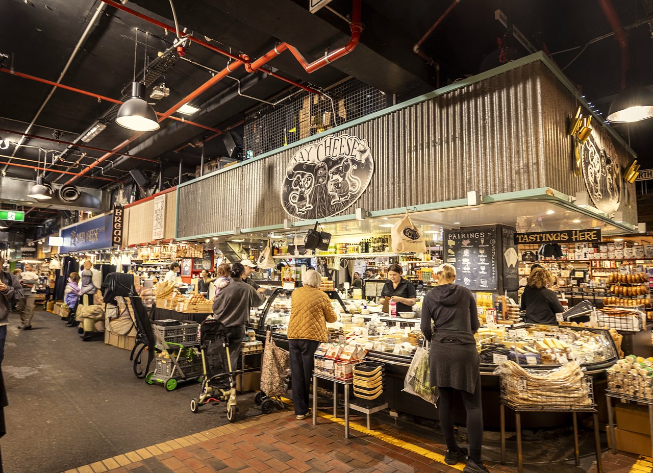 Shoppers at a cheese and deli stall inside the Adelaide Central Market.